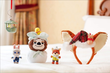 A group of stuffed animals on a bed

Description automatically generated