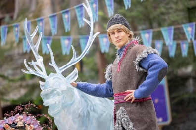 A person in garment holding a statue

Description automatically generated